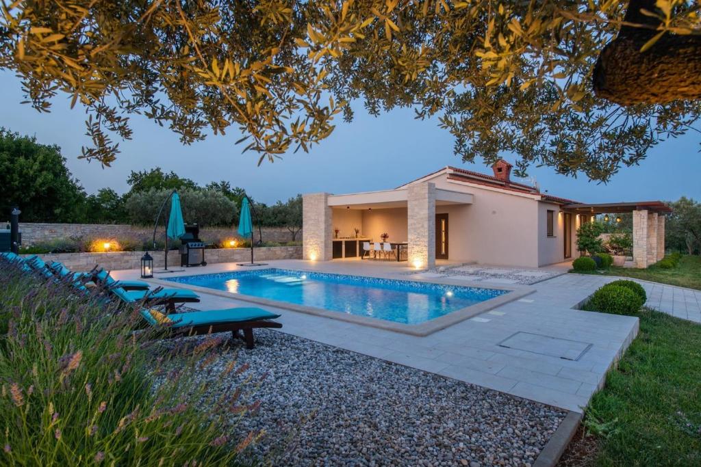 a swimming pool in the backyard of a house at Villa Silentio in Marčana