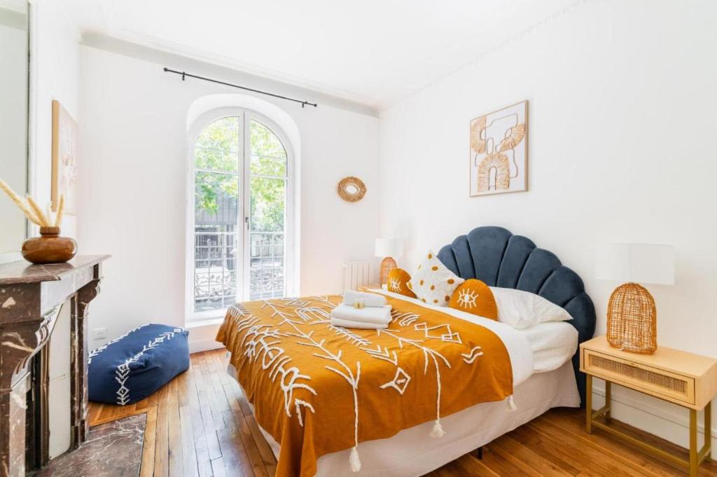 une chambre avec un lit et une cheminée dans l'établissement Appartement service 2 Pieces au Coeur du 19e - 4P, à Paris