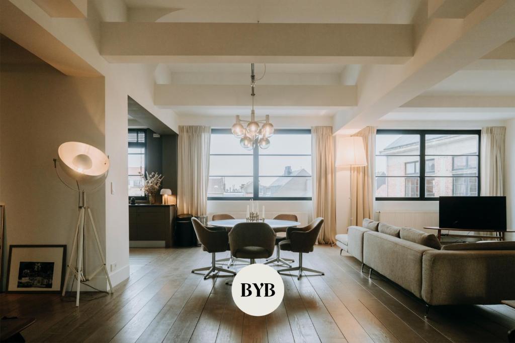 a living room with a couch and chairs and a table at Magnificent loft - 3 bedroom duplex in Brussels