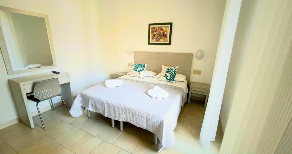 Łóżko lub łóżka w pokoju w obiekcie Hotel Bellini
