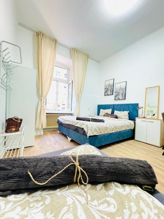 a bedroom with two beds and a window at Comfortable 5BR Shared Apt 10 Minute Walk to Matzleinsdorfer Platz in Vienna