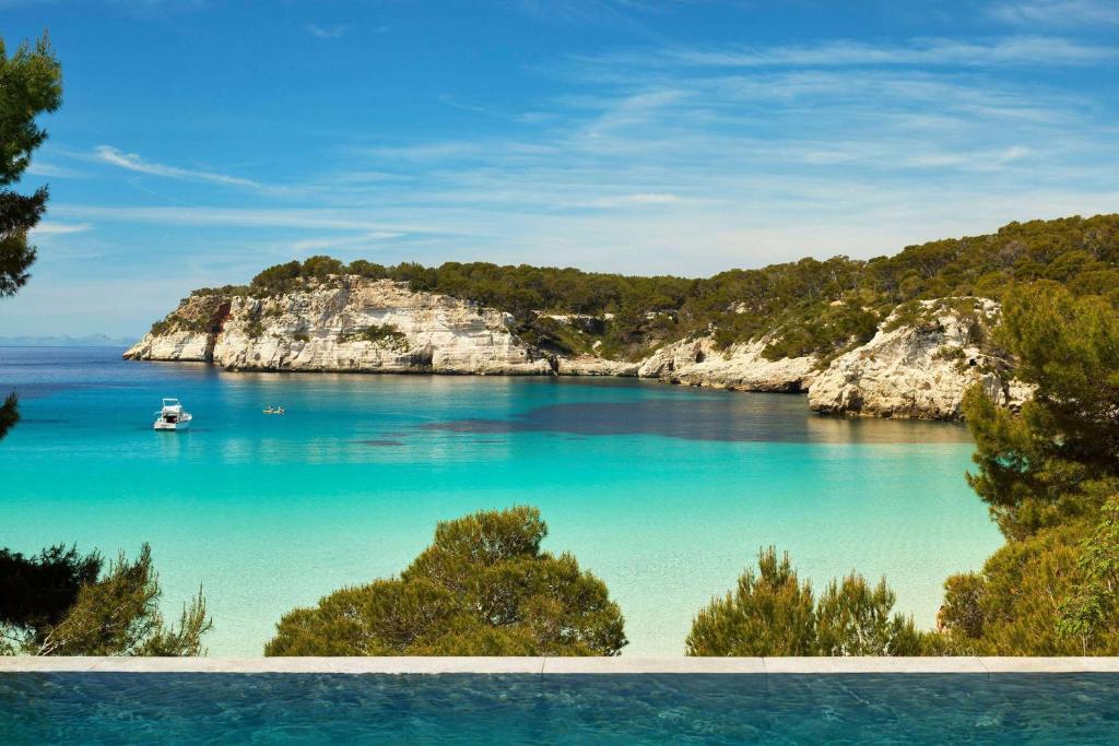 a view of a body of water with a boat in it at Meliá Cala Galdana in Cala Galdana