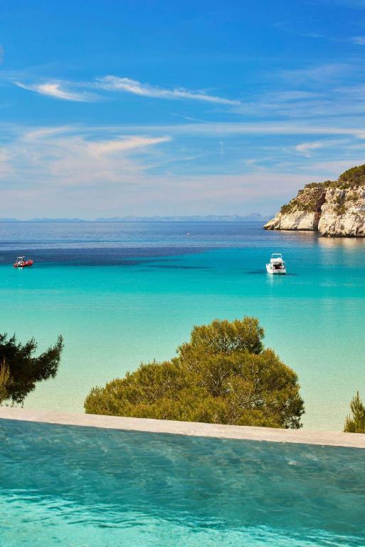 a view of a beach with boats in the water at Meliá Cala Galdana in Cala Galdana