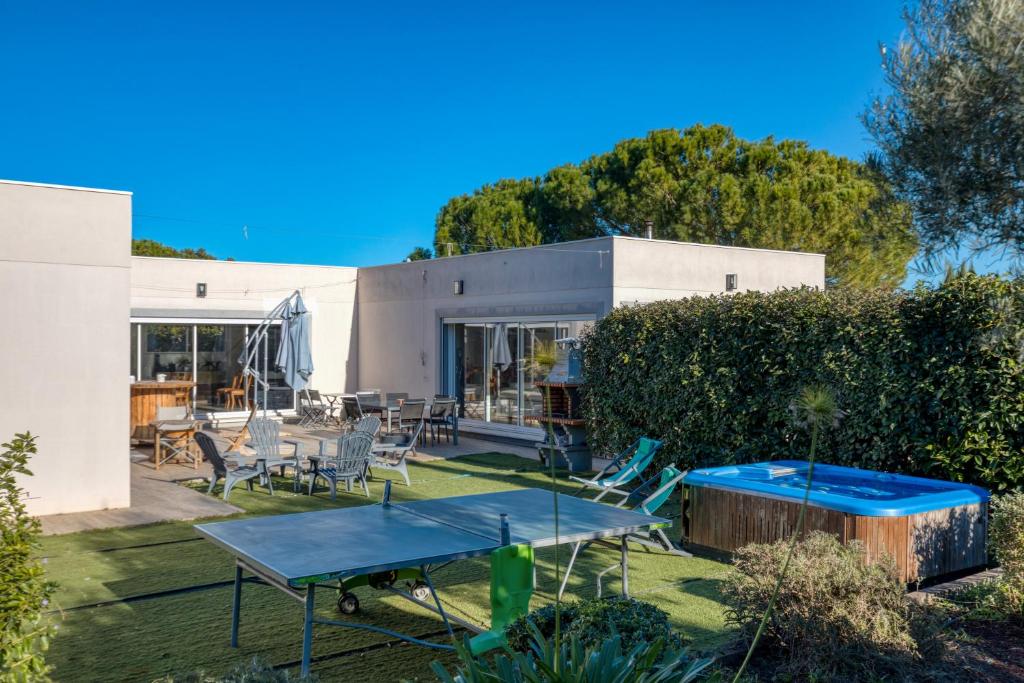 a house with a ping pong table in the yard at Villa L'Atrium in Alignan-du-Vent