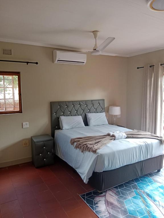 a bedroom with a large bed in a room at SNORING INN Mtubatuba in Mtubatuba