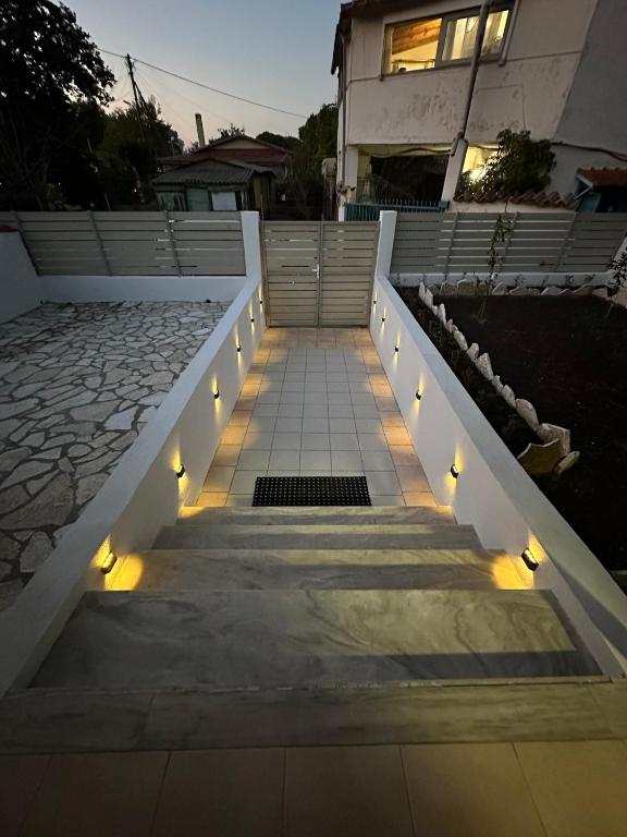 a set of stairs with lights in front of a house at Villa Nicole in Katarrákhion