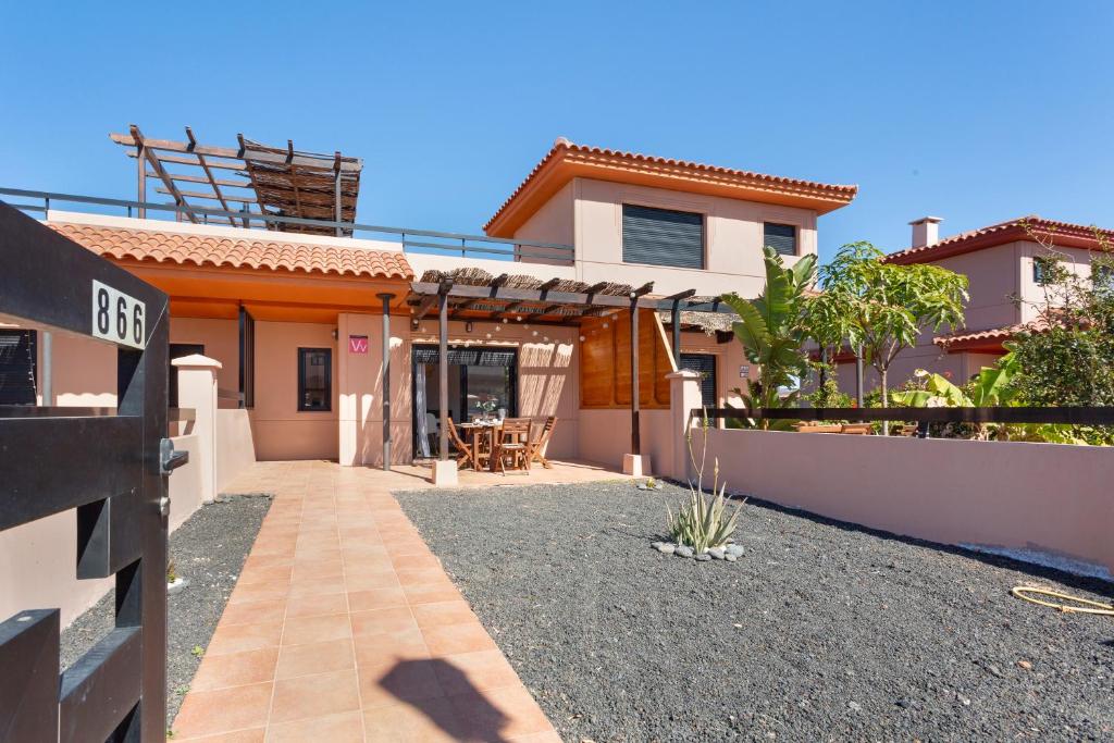 a house with a pathway leading to the front yard at Sweet Home Majanicho in Majanicho
