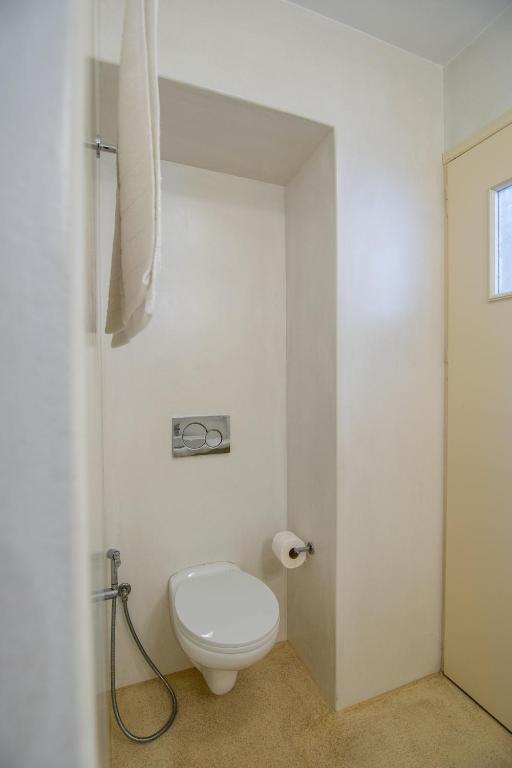a bathroom with a white toilet in a room at Tranquille House in Provatas