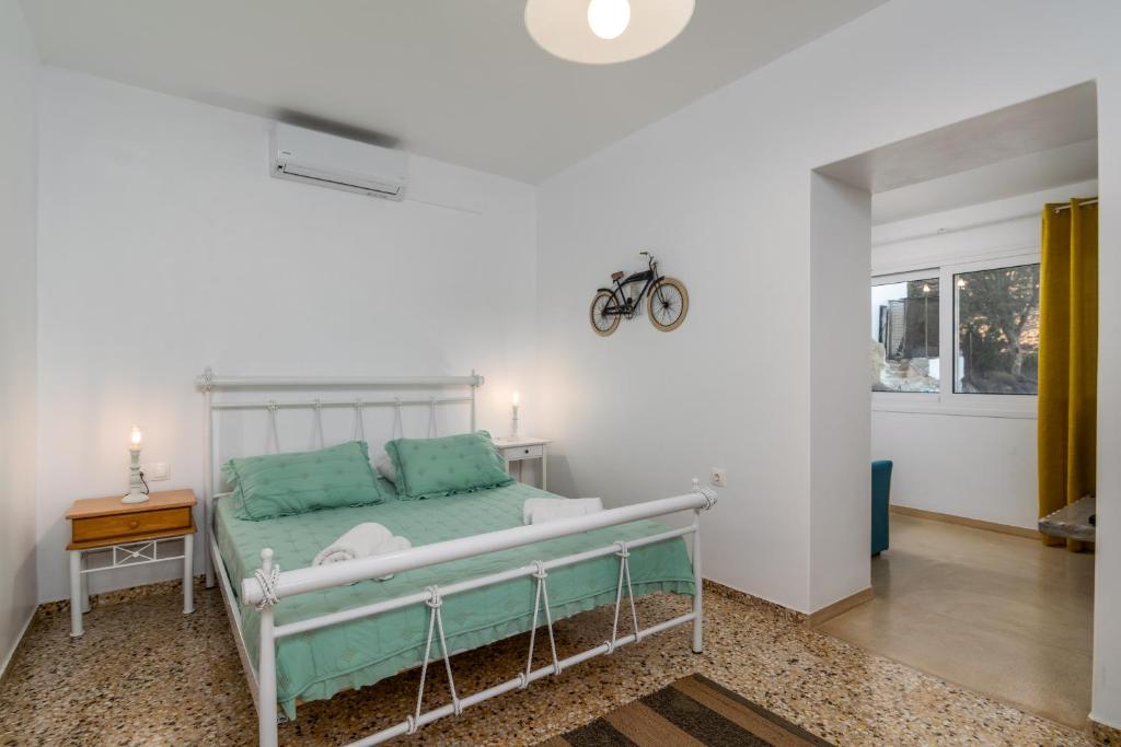 a bedroom with a bed with green pillows at Tranquille House in Provatas