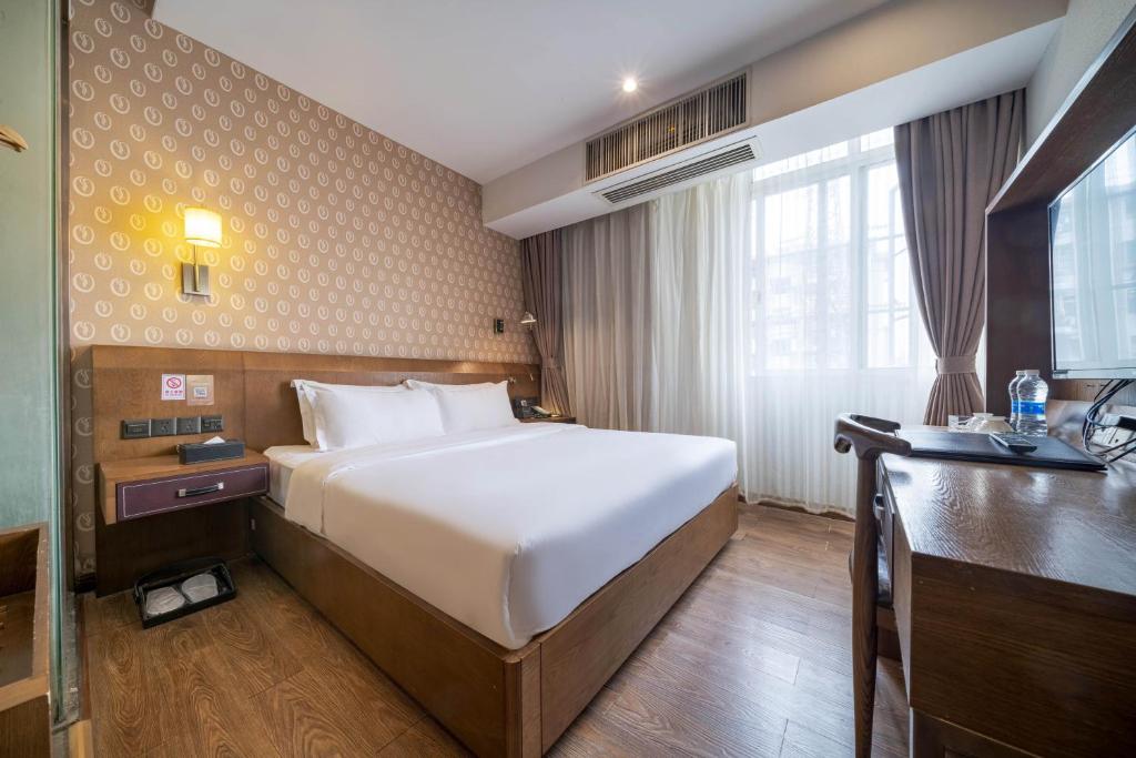 Postel nebo postele na pokoji v ubytování Xicheng International Hotel Guangzhou Sanyuanli Jiangxia Metro Station Branch
