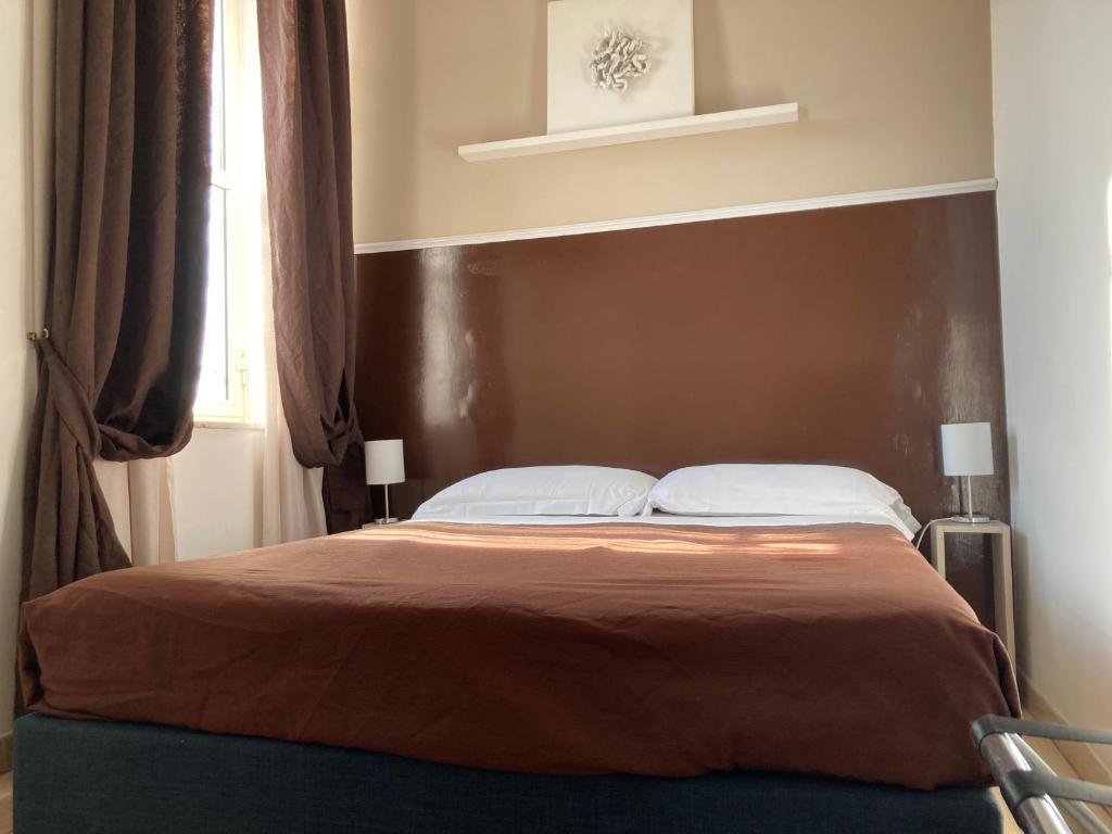 Postel nebo postele na pokoji v ubytování Hotel Indipendenza