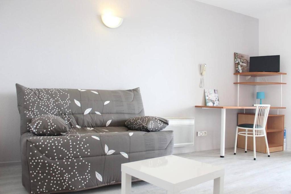 a living room with a couch and a table at Appt Studio LA ROCHELLE - LR030-A119Z in La Rochelle