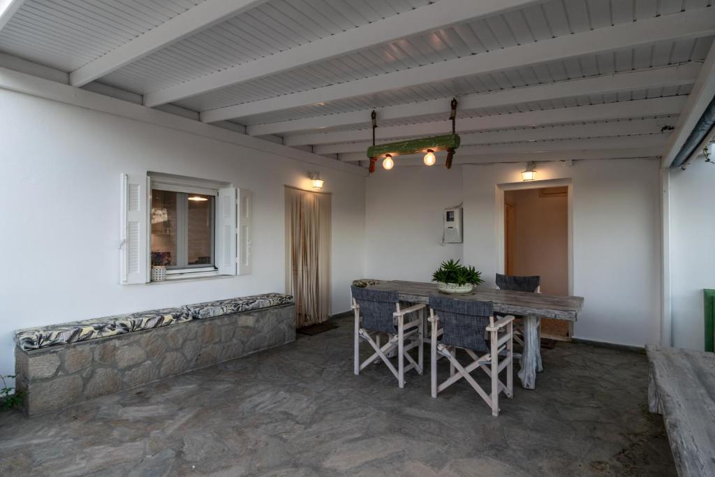 a patio with a table and chairs in a room at Tranquille House in Provatas