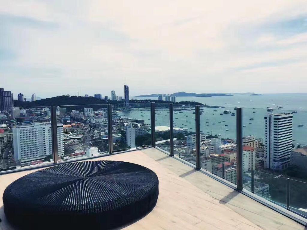 a balcony with an umbrella on top of a building at The Base海景网红顶层无边泳池 双卧室套房 in Pattaya Central