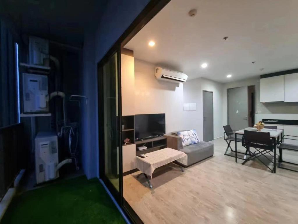 a living room with a couch and a dining room at The Base海景网红顶层无边泳池 双卧室套房 in Pattaya Central