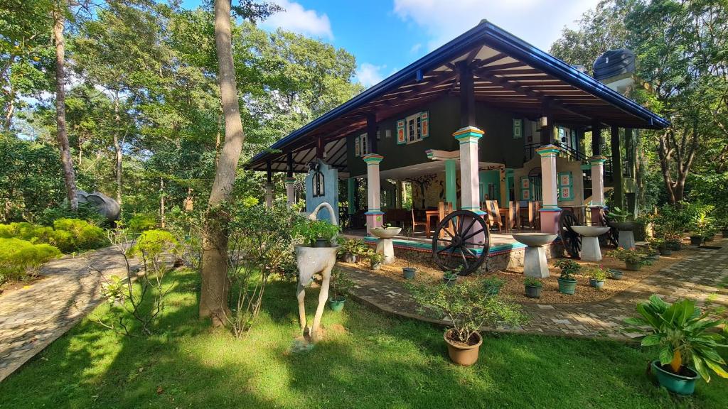 a house with a garden with plants in front of it at Rimaka Village - Tourist Board Approved Hotel in Habarana