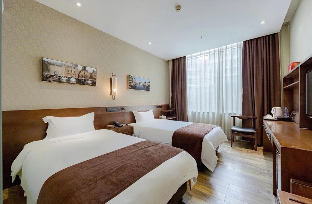 Postel nebo postele na pokoji v ubytování Xicheng International Hotel Guangzhou Sanyuanli Jiangxia Metro Station Branch
