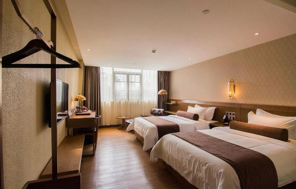 Postel nebo postele na pokoji v ubytování Xicheng International Hotel Guangzhou Sanyuanli Jiangxia Metro Station Branch