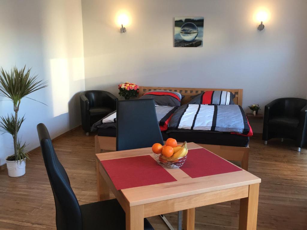 a living room with a table and a bed at Ferienwohnung - Marburg in Marbach