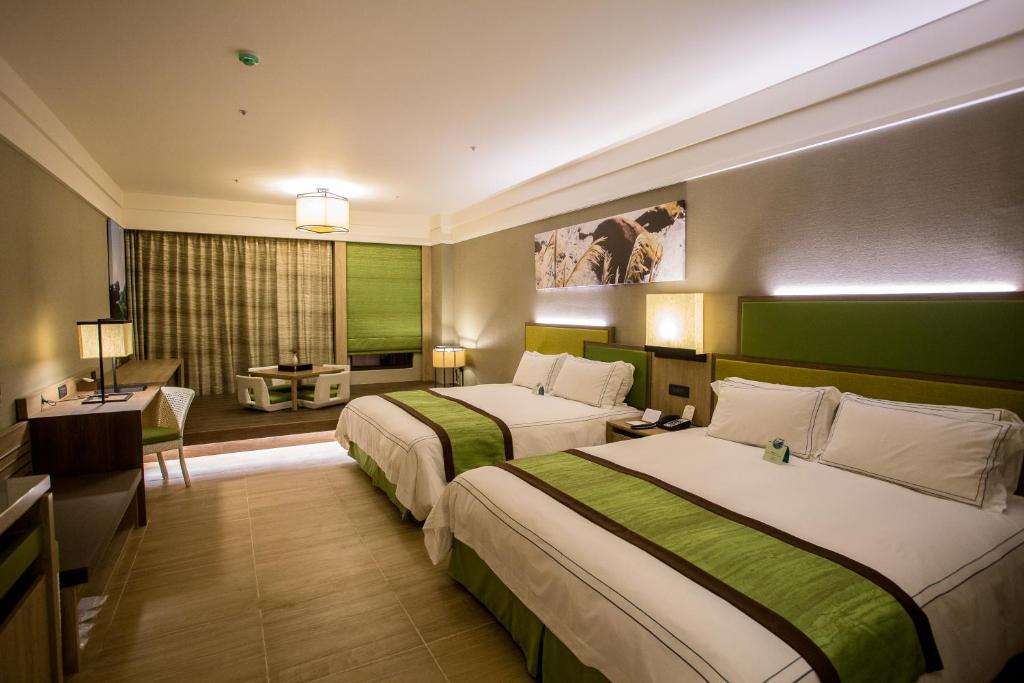 Postel nebo postele na pokoji v ubytování Fullon Hotel Fulong