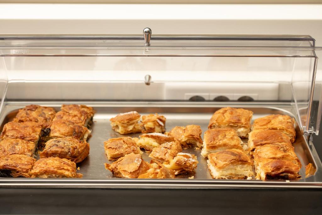 a baking pan filled with food in an oven at Oniro Boutique Hotel in Toroni