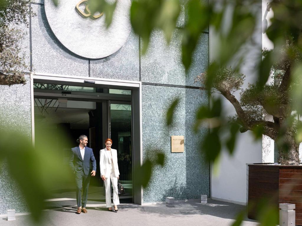 two people standing in the doorway of a building at Sofitel Casablanca Tour Blanche in Casablanca