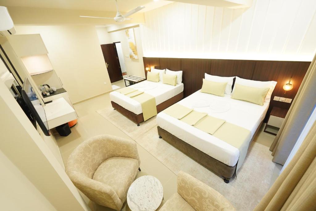 Postel nebo postele na pokoji v ubytování Hotel Grand Amanee