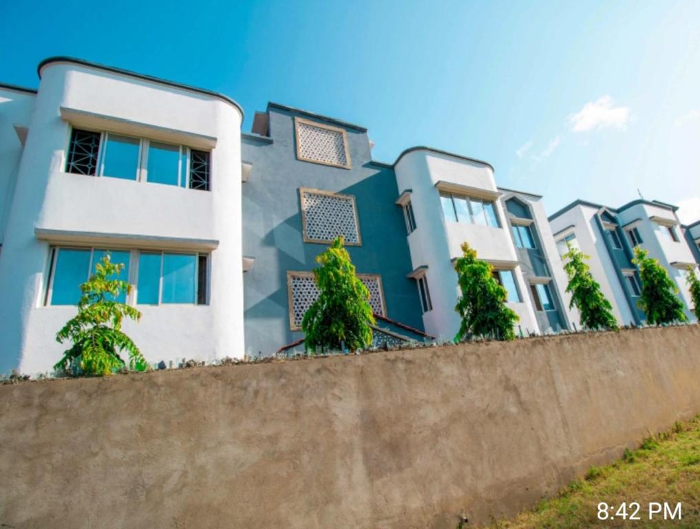 a row of houses behind a concrete wall at Haven Apartments in Malindi