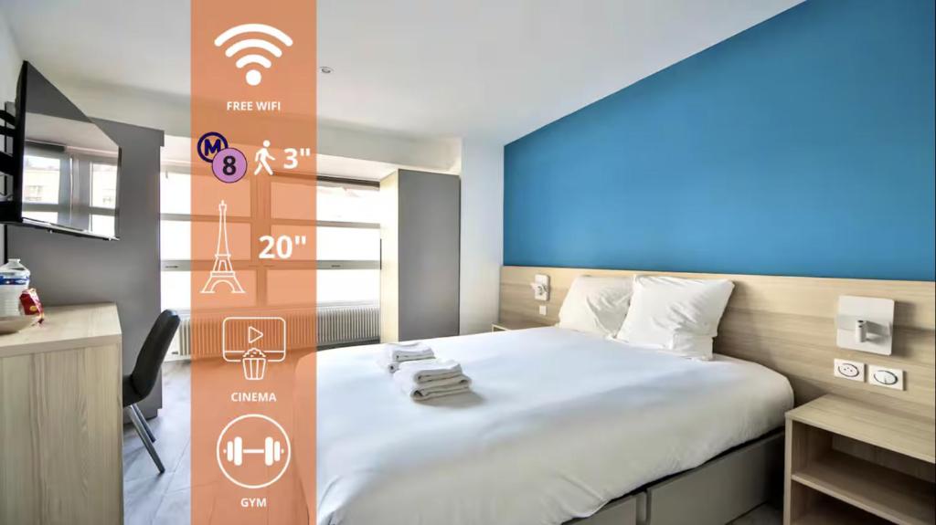 a bedroom with a large bed with a blue screen at 11.Studio#Charenton#Fitness#Cinema in Charenton-le-Pont