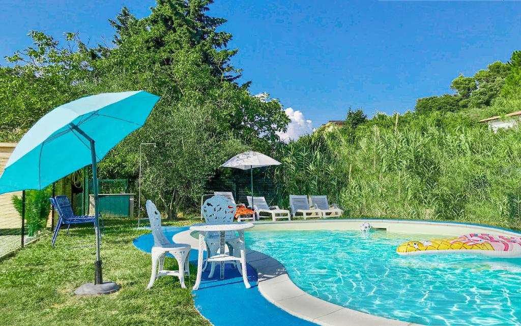 a pool with a table and chairs and an umbrella at Terrediliguria - Lerici in Lerici