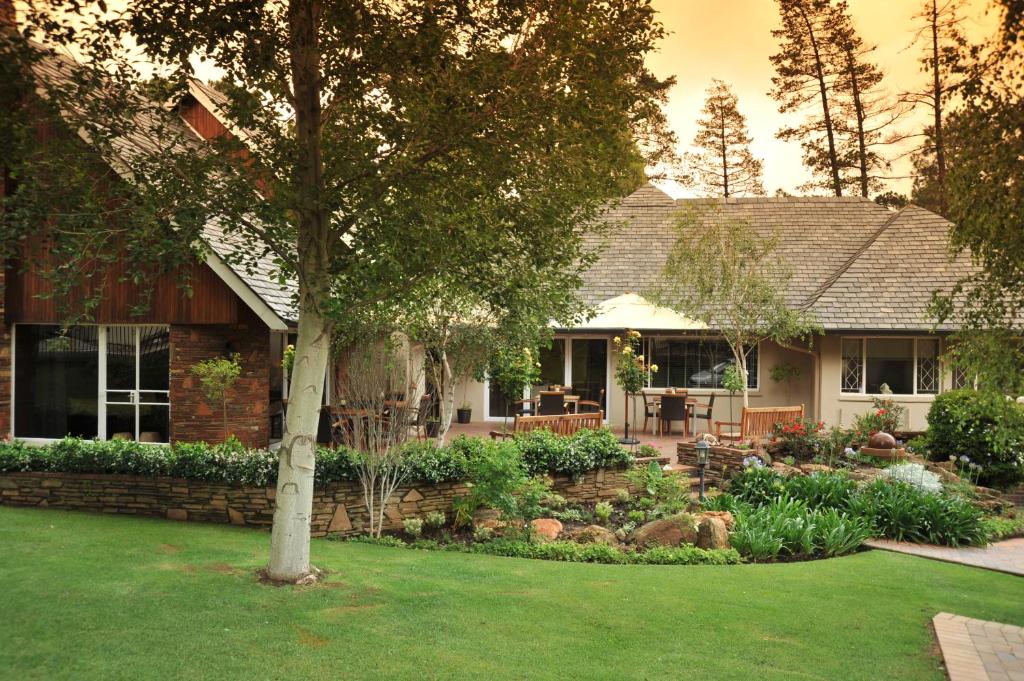 a house with a garden in front of it at Glendower View Guest House in Johannesburg