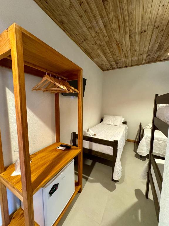 Postel nebo postele na pokoji v ubytování Caraíva Suítes