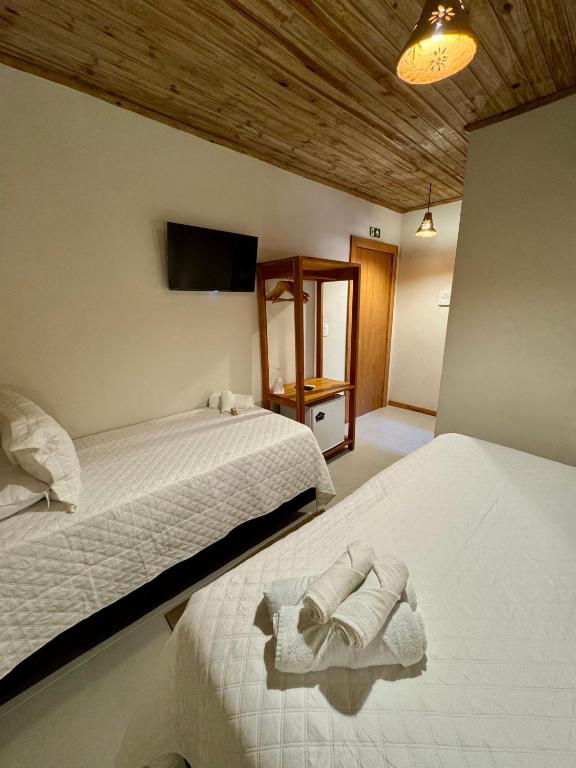 Postel nebo postele na pokoji v ubytování Caraíva Suítes