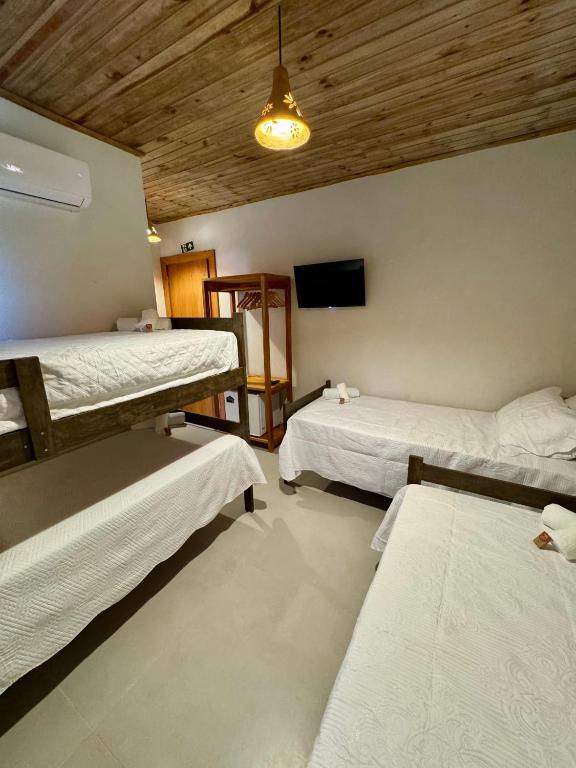 Postel nebo postele na pokoji v ubytování Caraíva Suítes