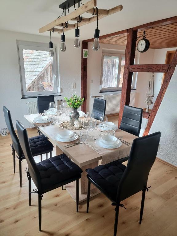 a large wooden table with chairs and a dining room at FeWo Lichtblick in Mengen