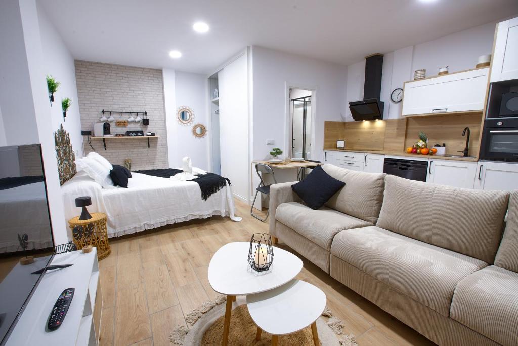 a living room with a couch and a bed at Cuencaloft el Rincón especial de Cuenca in Cuenca