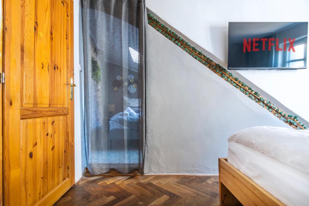 a bedroom with a bed next to a door at 20 seconds to Charles Bridge in Prague
