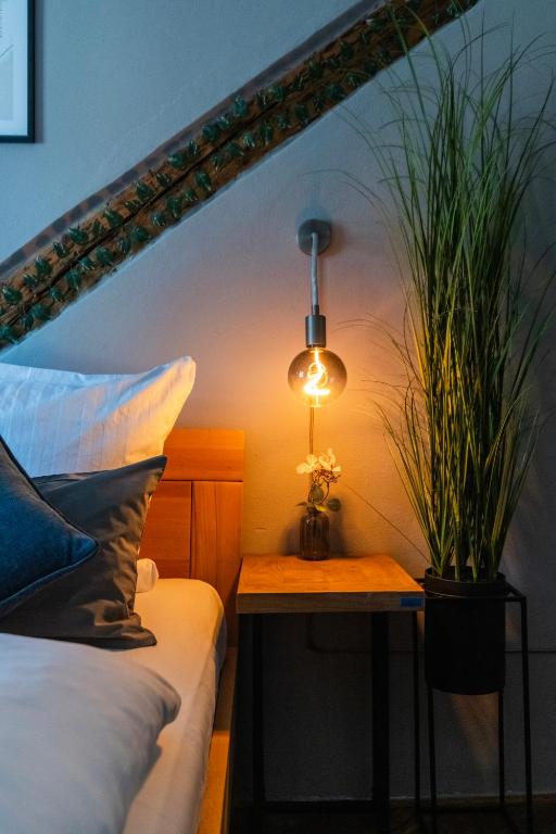 a bedroom with a bed and a table with a potted plant at 20 seconds to Charles Bridge in Prague