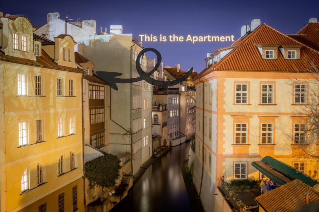 a view of a river between buildings with the words this is the apartment at 20 seconds to Charles Bridge in Prague