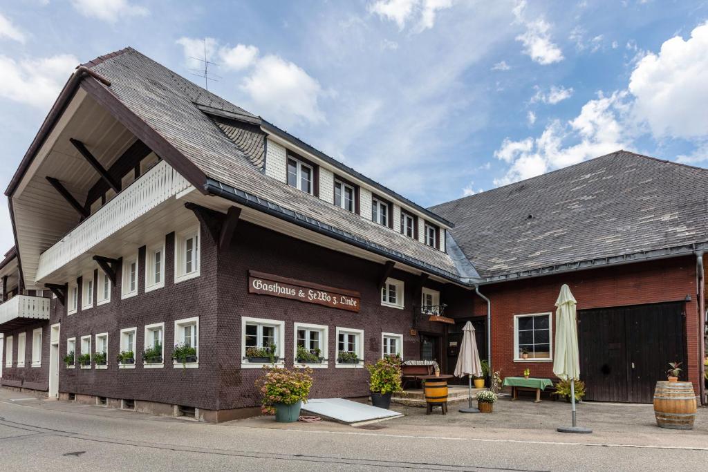 a brown building with a roof at Gasthaus zur Linde und Fewo in Menzenschwand
