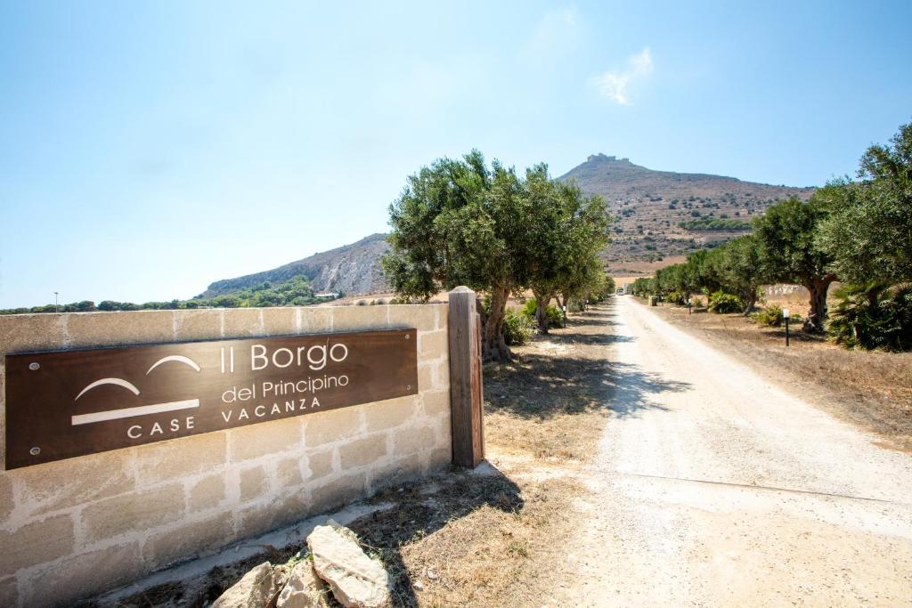 un cartello per il distributore di benzina I lobo-olio compressore su una strada sterrata. di Il Borgo Del Principino a Favignana