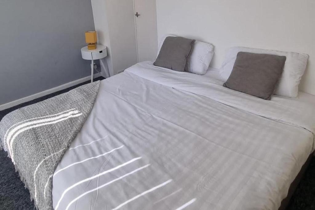 a white bed with two pillows on top of it at Doncaster-House-Sleeps8-Parking-Garden in Doncaster