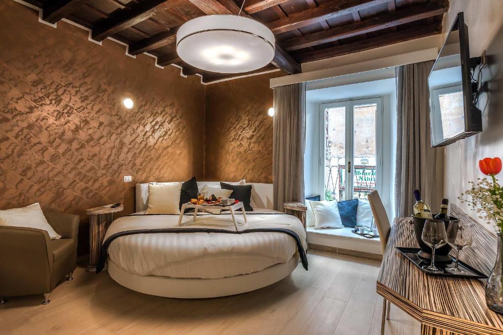 a bedroom with a large bed and a window at Spagna Luxury'n Trevi in Rome