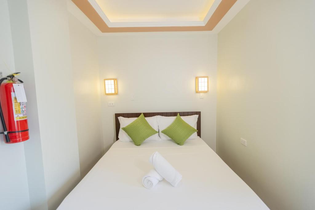 Ένα ή περισσότερα κρεβάτια σε δωμάτιο στο Anahaw Seaside Inn
