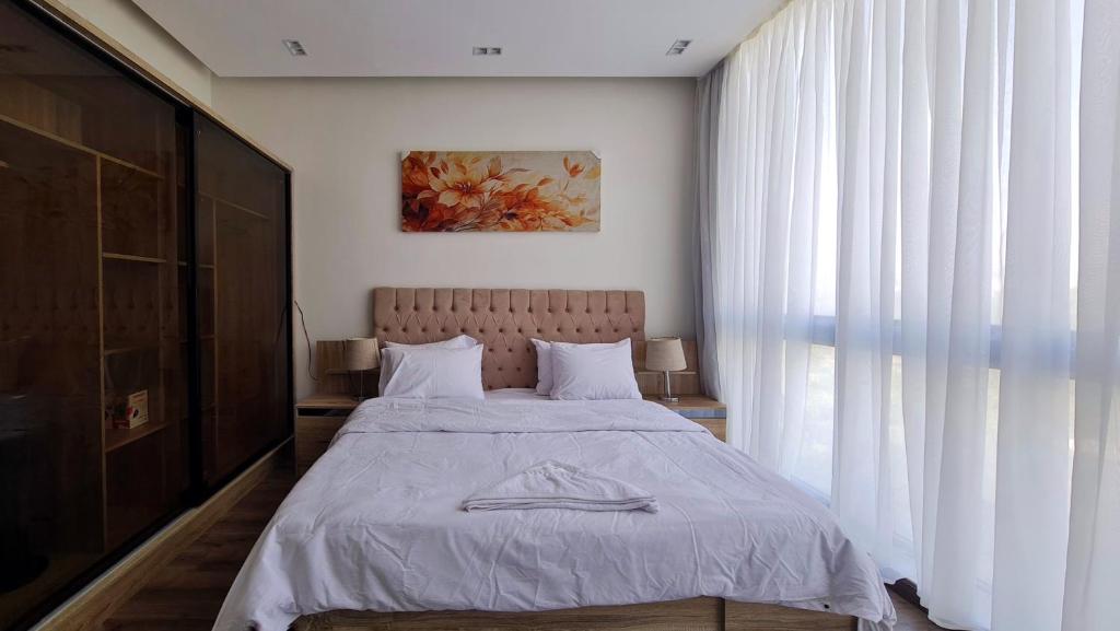 Voodi või voodid majutusasutuse Axxodia- Apartments In Lake View Residence toas