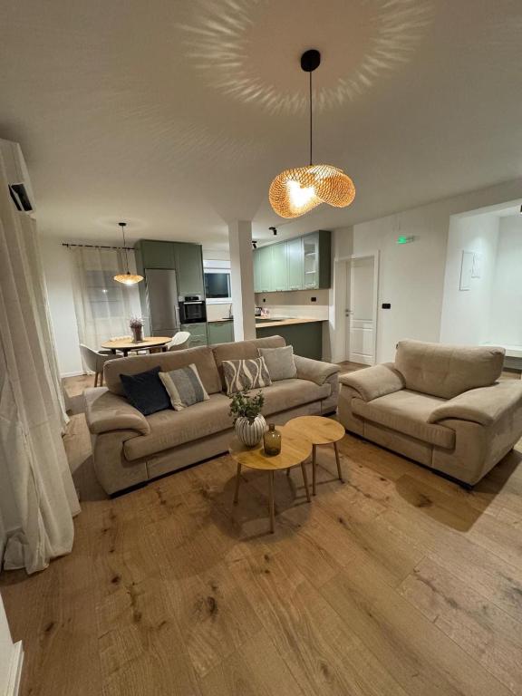 a living room with two couches and a table at Matea Apartment in Čitluk