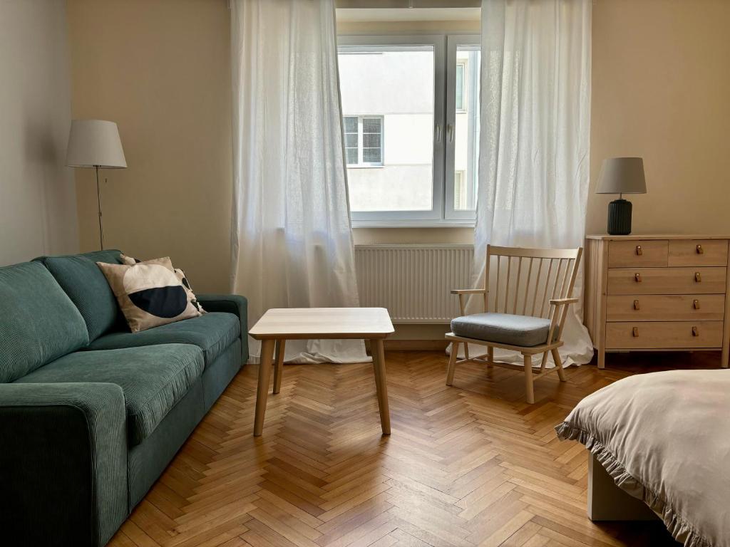a living room with a green couch and a table at Śląska 33 in Gdynia