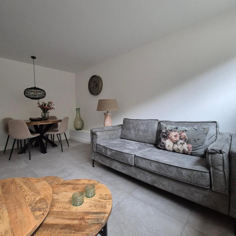 a living room with a couch and a table at Het Klokkenest in Katwijk aan Zee