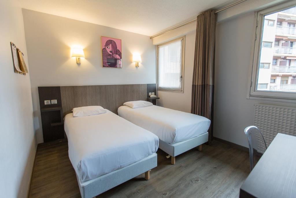 Postel nebo postele na pokoji v ubytování Hotel Gascogne