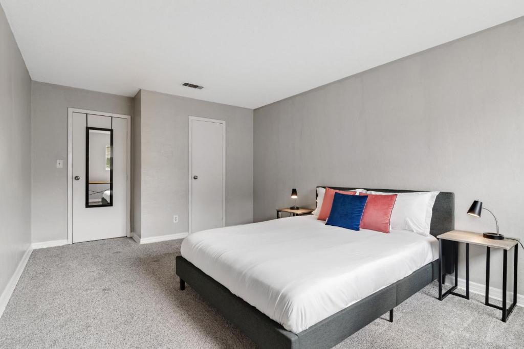 a bedroom with a large bed and two tables at Sweetwater 5f I Beautiful 1bd Apt I Free Parking in Gainesville